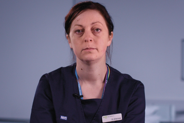 Dr Ruth Sharrock sitting on hospital ward